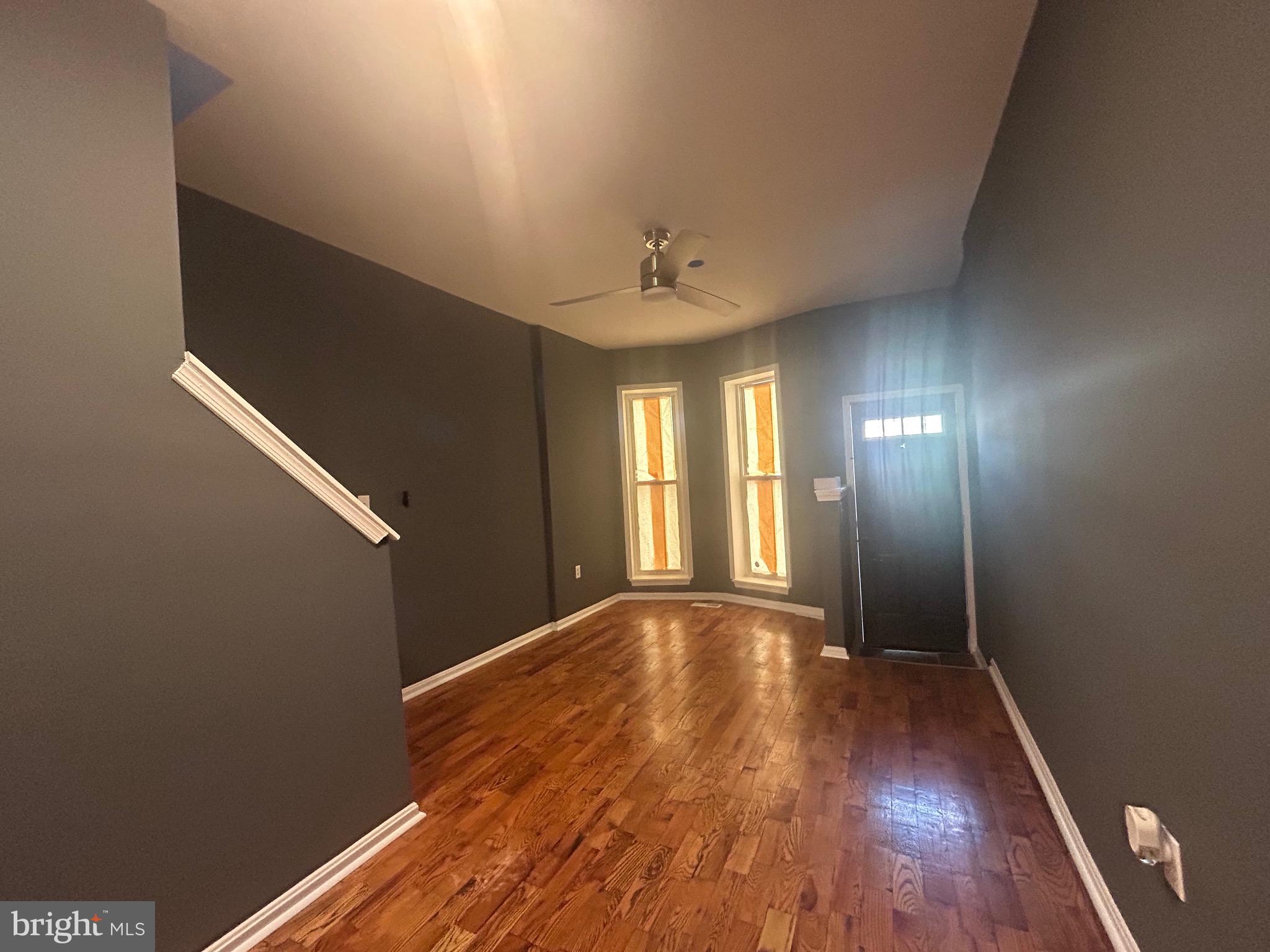 1516 North Mount Street Baltimore, MD 21217 - Photo 3 of 30 a view of an empty room with wooden floor and a window