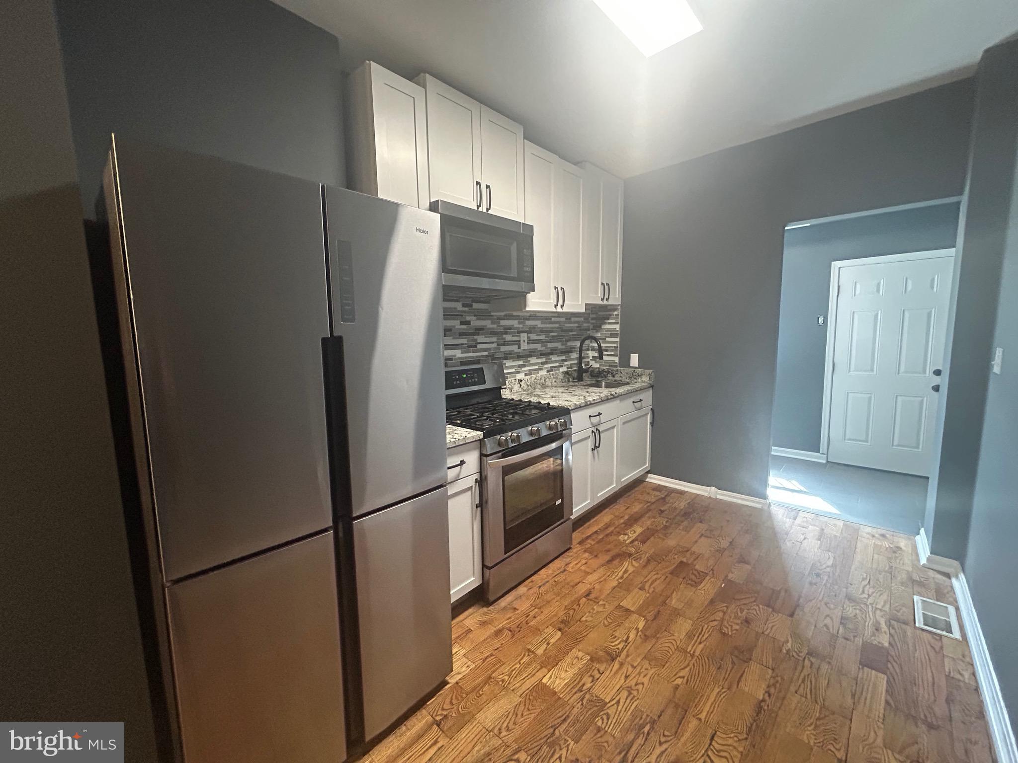 1516 North Mount Street Baltimore, MD 21217 - Photo 9 of 30 a kitchen with stainless steel appliances granite countertop a refrigerator stove and sink