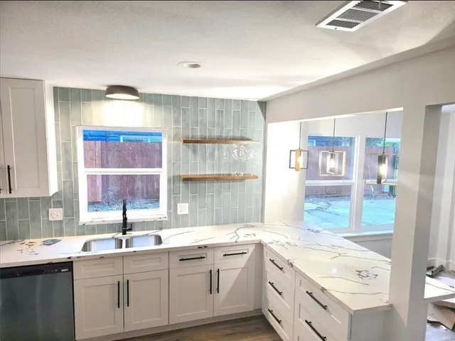 a kitchen with a sink stove and cabinets