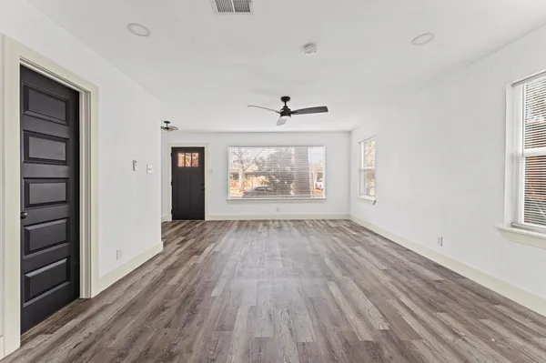 wooden floor in an empty room with a window