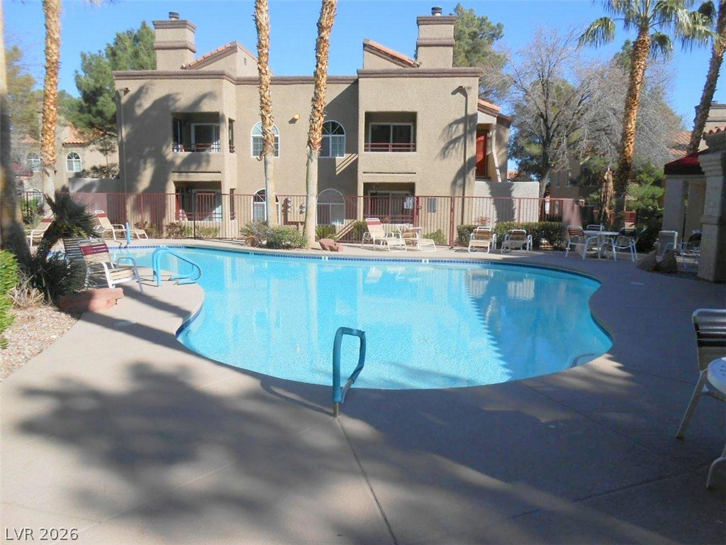 9325 West Desert Inn Road, Unit 132 Las Vegas, NV 89117 - Photo 21 of 36 A refreshing pool awaits, nestled among the inviting architectural facade and tropical landscaping.