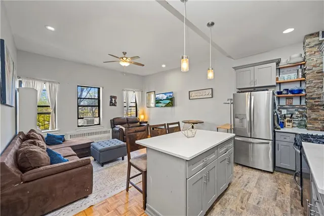 a kitchen with stainless steel appliances kitchen island granite countertop a sink and cabinets