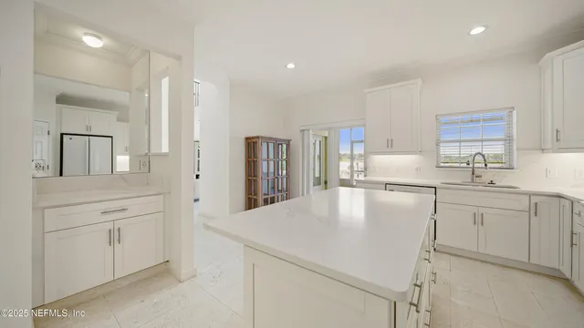 a kitchen with stainless steel appliances white cabinets and wooden floors