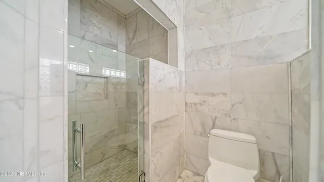 a bathroom with a granite countertop toilet a sink and bathtub