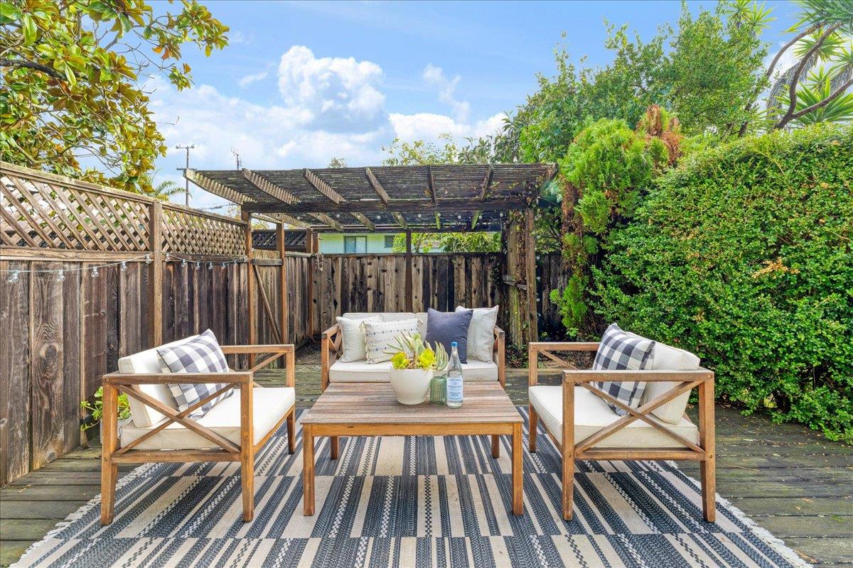 2908 Sandy Lane Santa Cruz, CA 95062 - Photo 23 of 28 a view of a patio with table and chairs and wooden floor