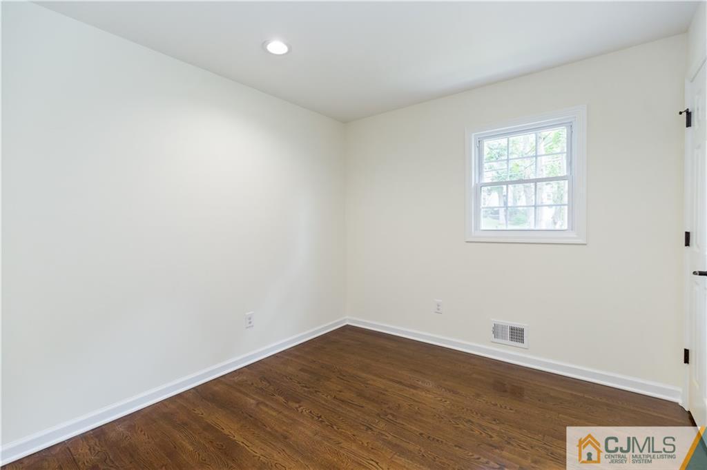 1264 Washington Valley Road Bridgewater, NJ 08807 - Photo 17 of 25 an empty room with wooden floor and windows