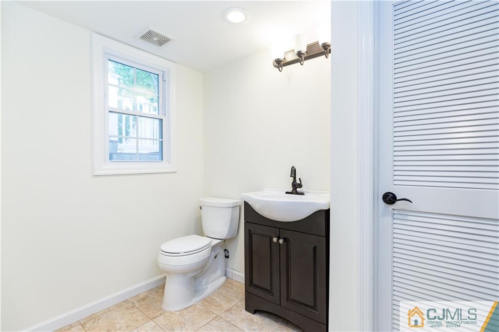 1264 Washington Valley Road Bridgewater, NJ 08807 - Photo 22 of 25 a bathroom with a toilet a sink and mirror