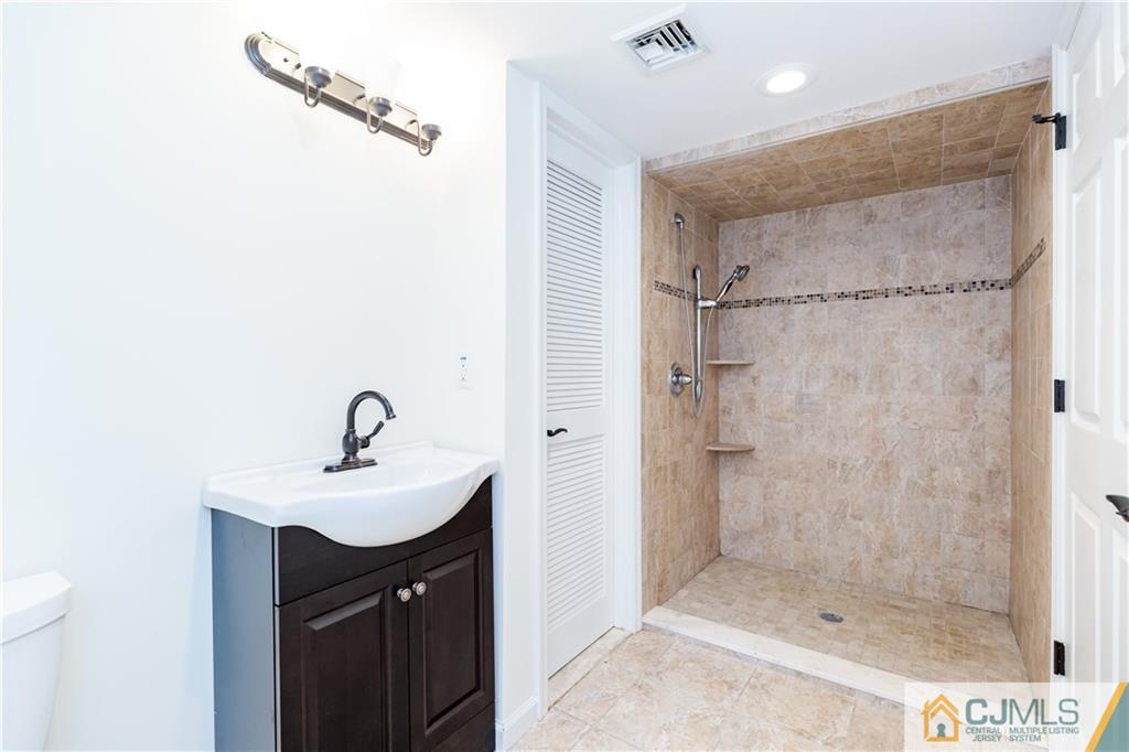 1264 Washington Valley Road Bridgewater, NJ 08807 - Photo 23 of 25 a bathroom with a sink a mirror and shower