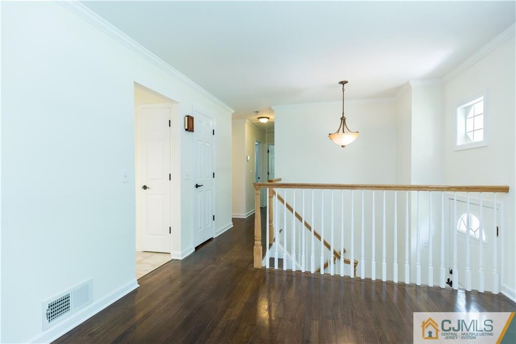 1264 Washington Valley Road Bridgewater, NJ 08807 - Photo 4 of 25 a view of a hallway with wooden floor and staircase
