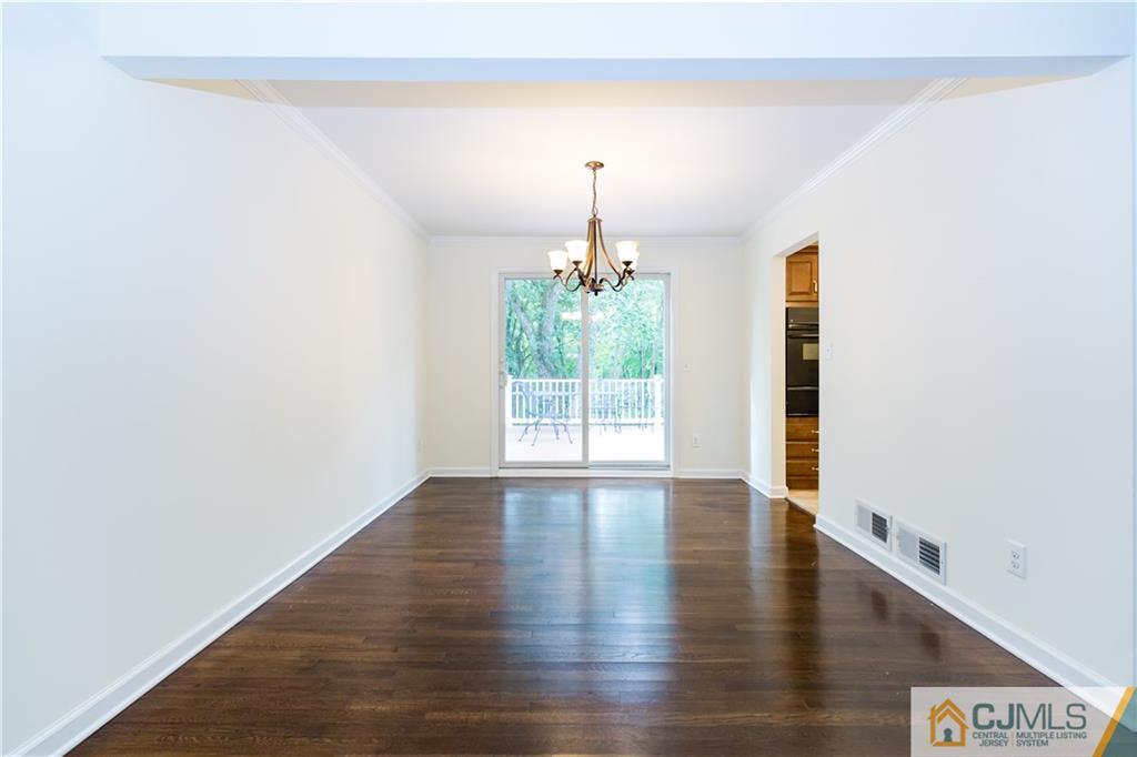 1264 Washington Valley Road Bridgewater, NJ 08807 - Photo 6 of 25 a view of an empty room with window and wooden floor