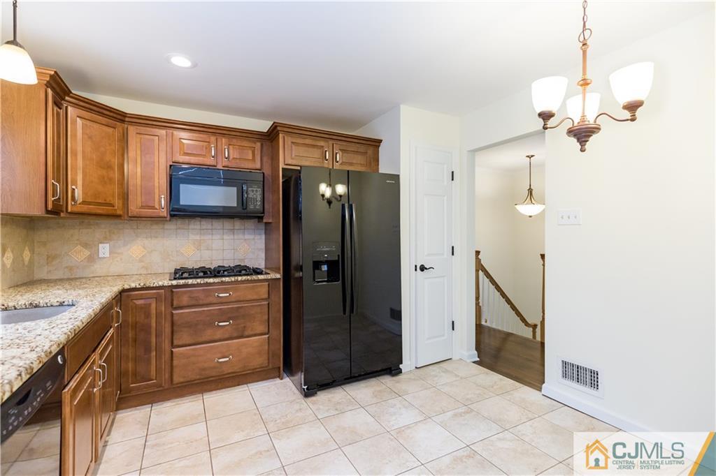 1264 Washington Valley Road Bridgewater, NJ 08807 - Photo 7 of 25 a kitchen with stainless steel appliances granite countertop a refrigerator and a stove