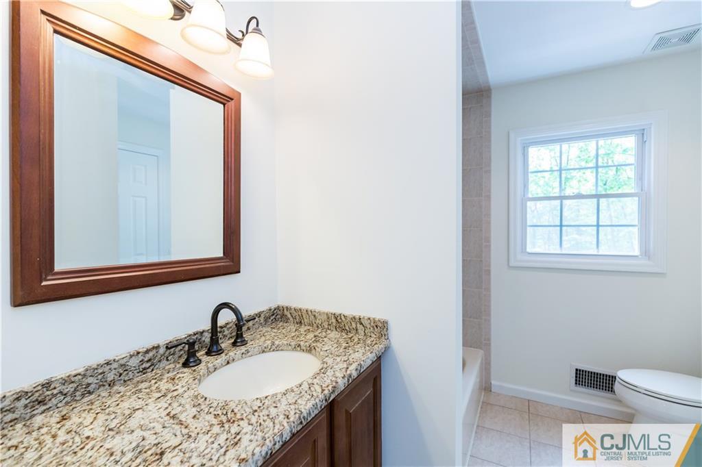 1264 Washington Valley Road Bridgewater, NJ 08807 - Photo 10 of 25 a bathroom with a granite countertop sink toilet and mirror