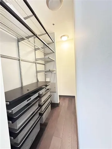 a view of a room with wooden floor and white walls