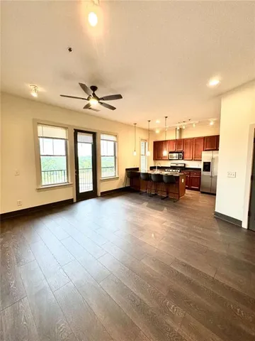 a view of a livingroom with furniture and a kitchen