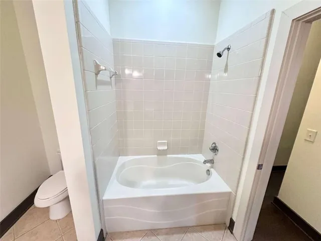 a bathroom with a sink a toilet a shower and a mirror