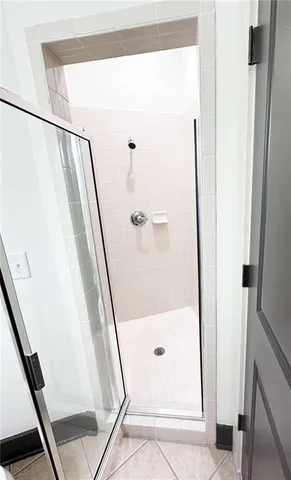 a bathroom with a glass door shower