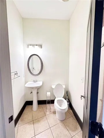 a bathroom with a toilet a sink and a mirror