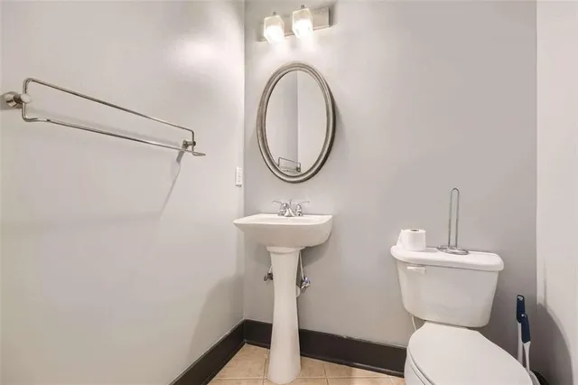 a bathroom with a toilet a sink and a mirror