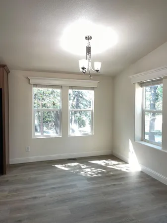an empty room with closet and windows