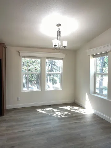 an empty room with closet and windows