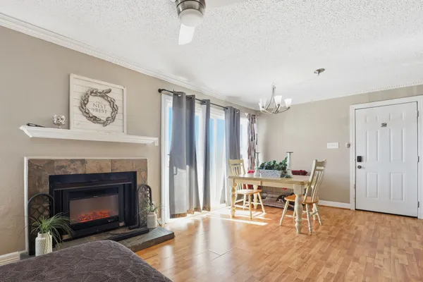 a living room with furniture a fireplace and a table
