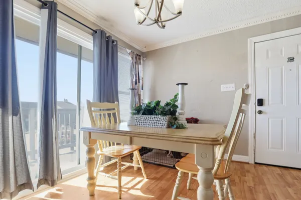a dining room with furniture and wooden floor