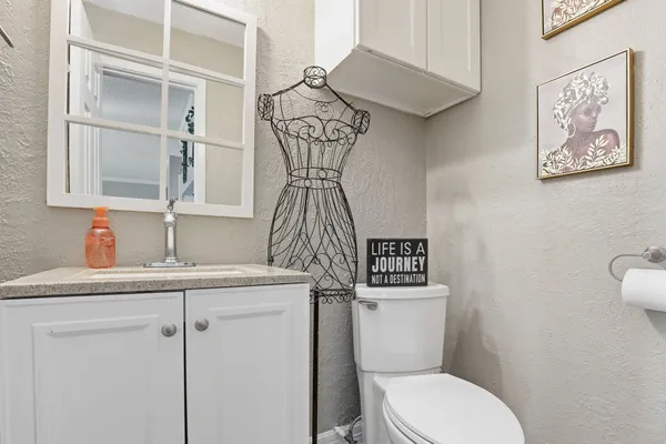 a bathroom with a toilet sink and mirror