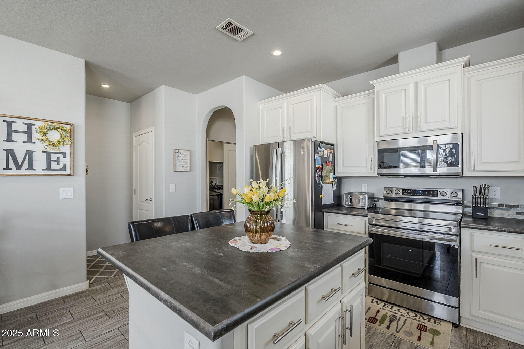 650 North Hawes Road, Unit 3215 Mesa, AZ 85207 - Photo 12 of 68 a kitchen with stainless steel appliances granite countertop a sink a stove and white cabinets