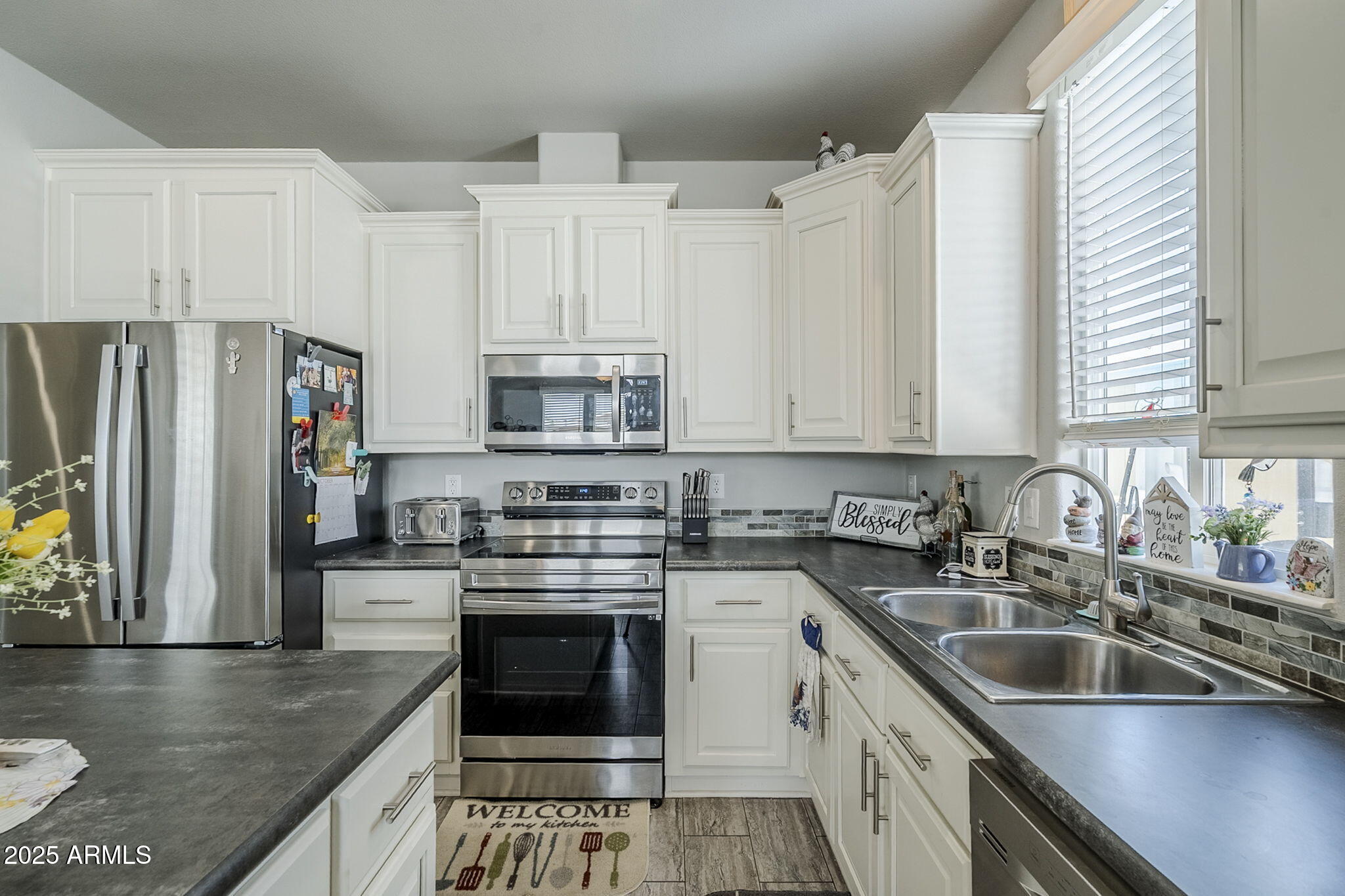650 North Hawes Road, Unit 3215 Mesa, AZ 85207 - Photo 13 of 68 a kitchen with stainless steel appliances granite countertop a sink stove and refrigerator