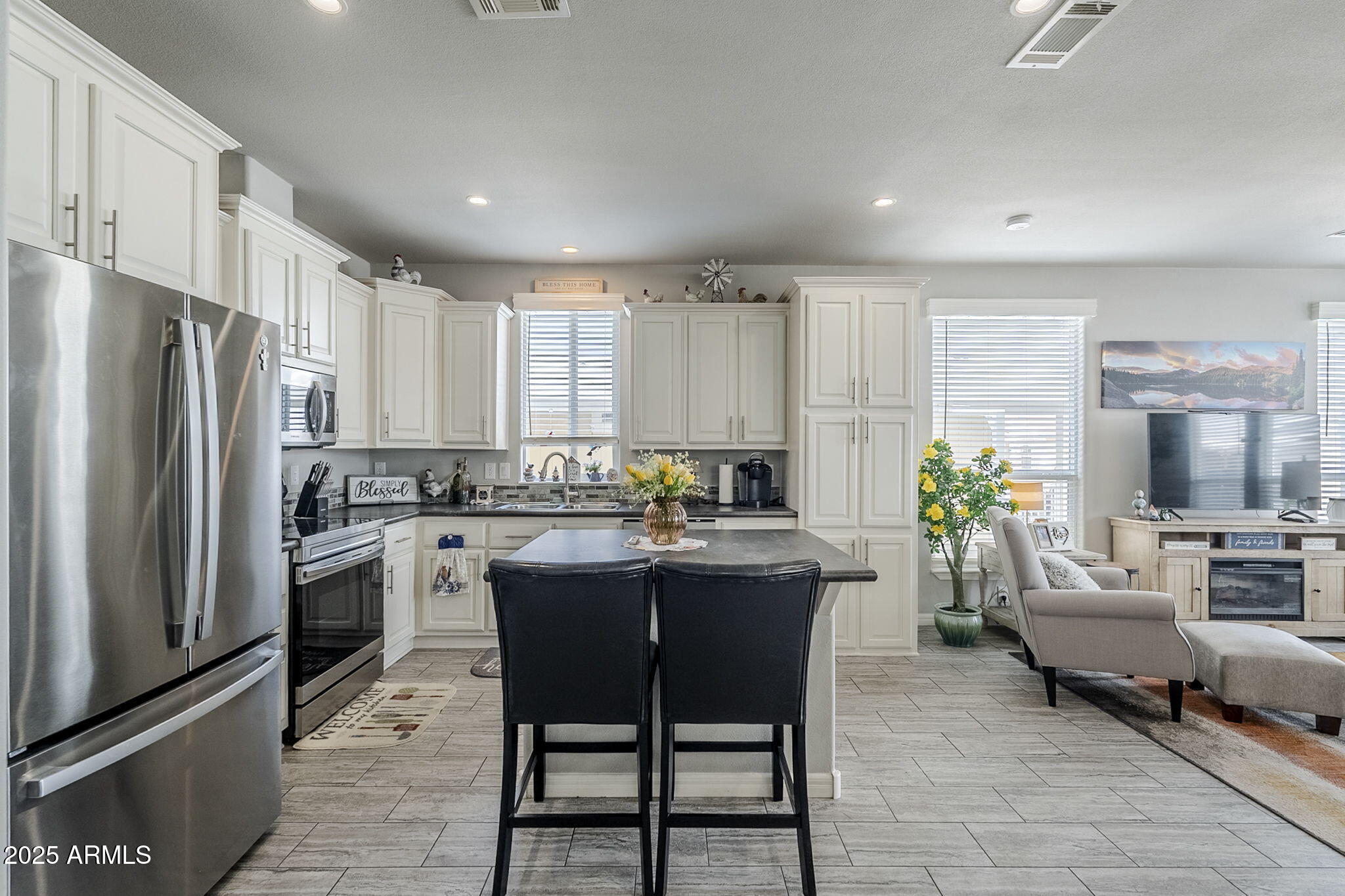 650 North Hawes Road, Unit 3215 Mesa, AZ 85207 - Photo 15 of 68 a kitchen with a table chairs refrigerator and cabinets