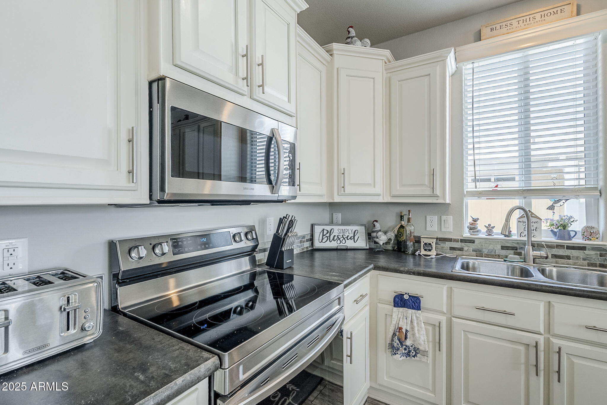 650 North Hawes Road, Unit 3215 Mesa, AZ 85207 - Photo 17 of 68 a kitchen with stainless steel appliances white cabinets and a stove top oven