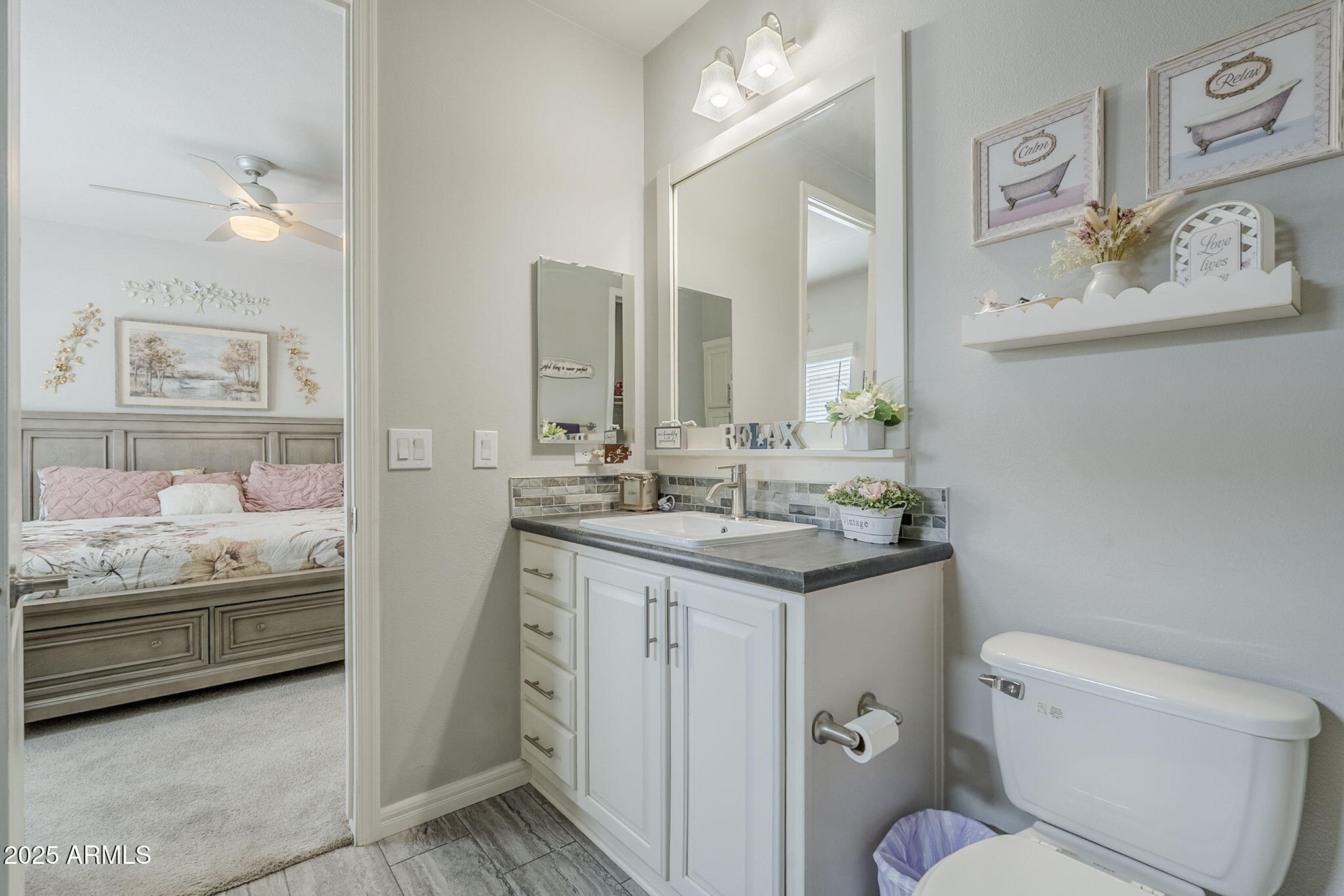 650 North Hawes Road, Unit 3215 Mesa, AZ 85207 - Photo 27 of 68 a bathroom with a toilet sink and mirror