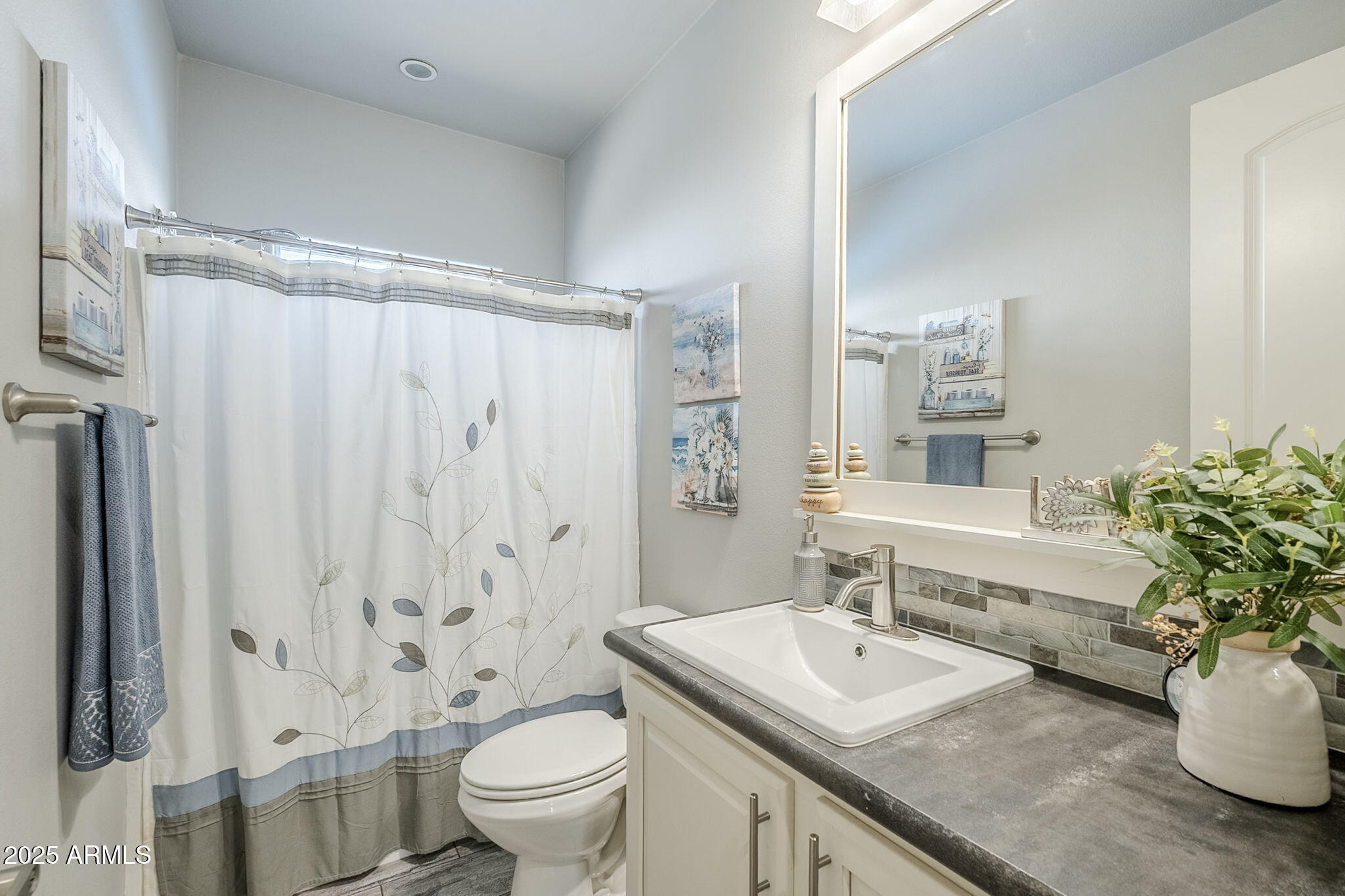 650 North Hawes Road, Unit 3215 Mesa, AZ 85207 - Photo 30 of 68 a bathroom with a granite countertop sink a toilet and a mirror