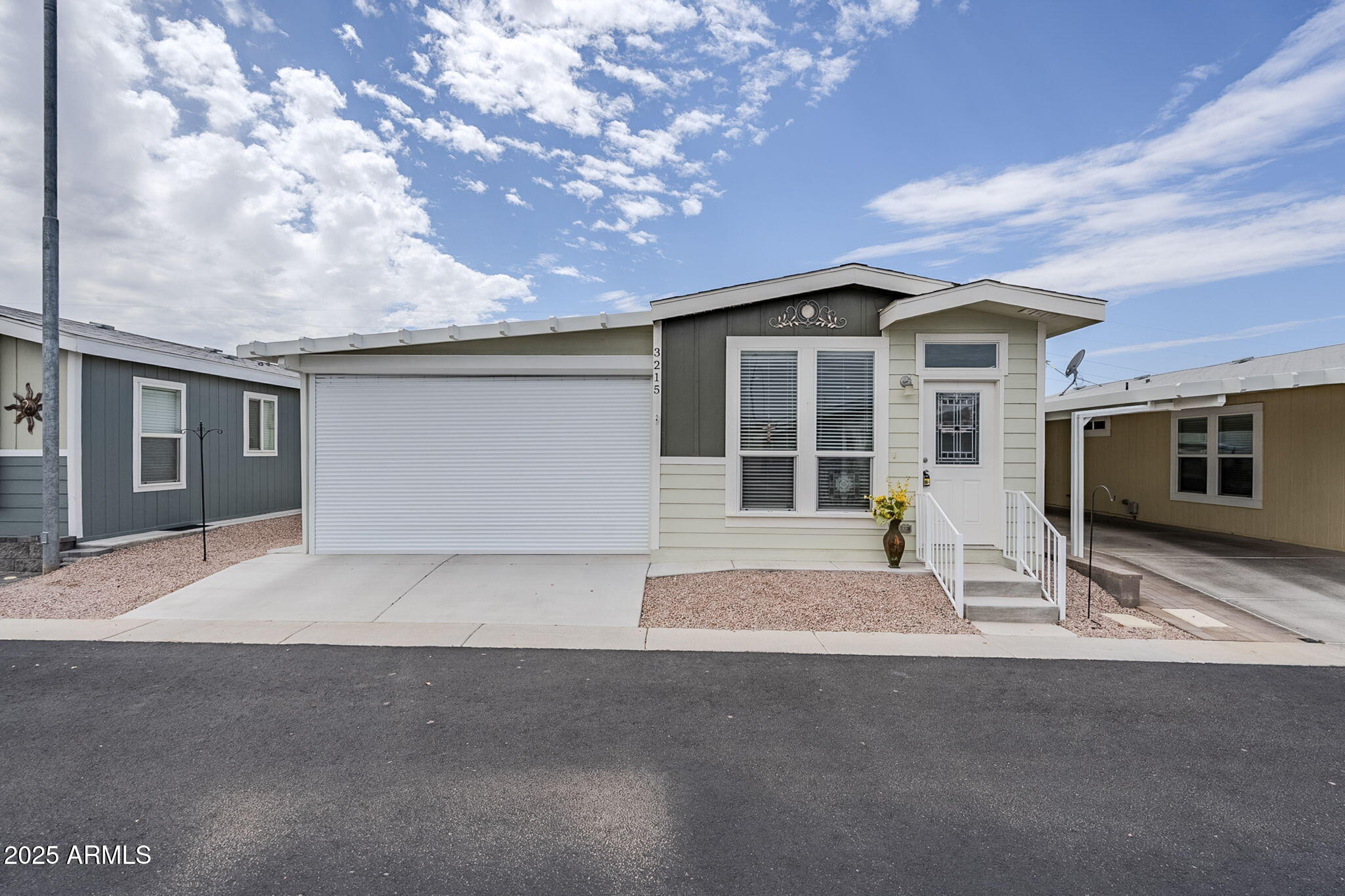 650 North Hawes Road, Unit 3215 Mesa, AZ 85207 - Photo 65 of 68 a front view of a house with a garden and yard
