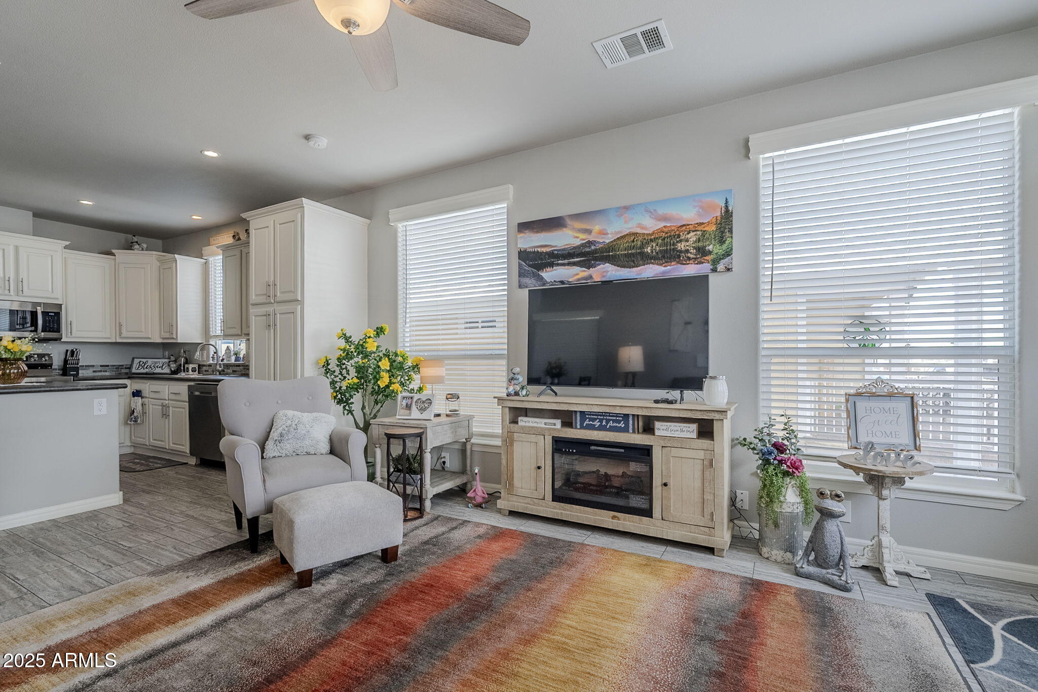 650 North Hawes Road, Unit 3215 Mesa, AZ 85207 - Photo 6 of 68 a living room with furniture and a flat screen tv