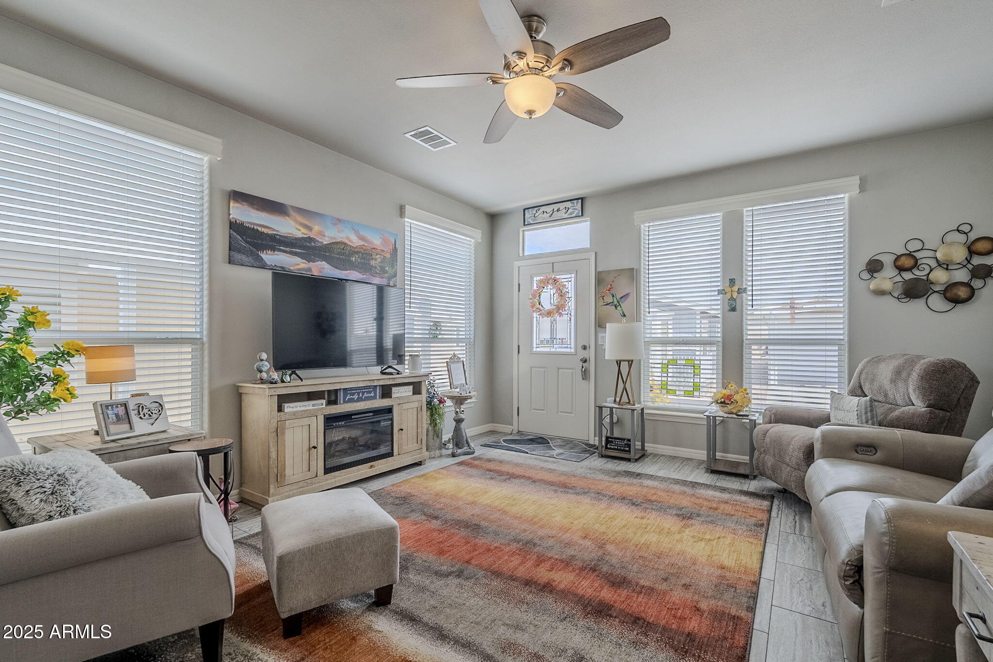 650 North Hawes Road, Unit 3215 Mesa, AZ 85207 - Photo 7 of 68 a living room with furniture and a flat screen tv