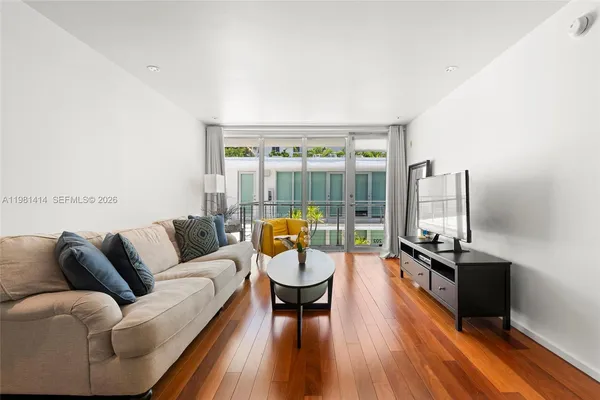 a living room with furniture and a floor to ceiling window