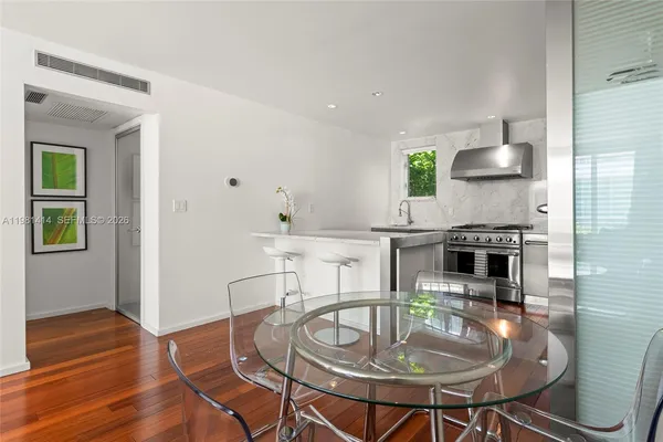 a dining room with furniture and wooden floor