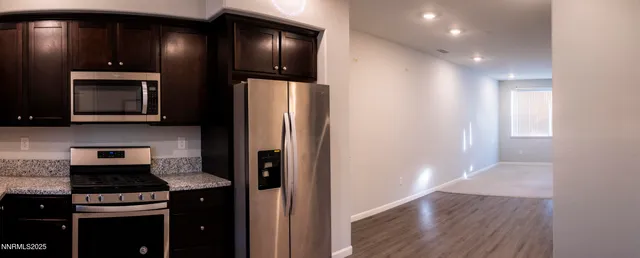 a kitchen with stainless steel appliances wooden cabinets and a stove
