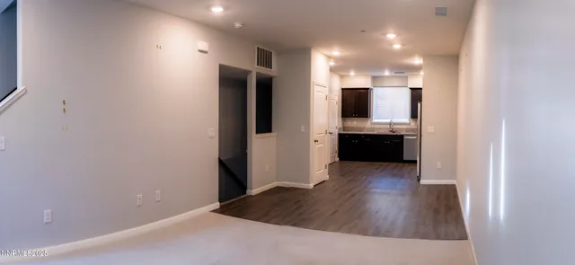 a view of kitchen with sink and refrigerator