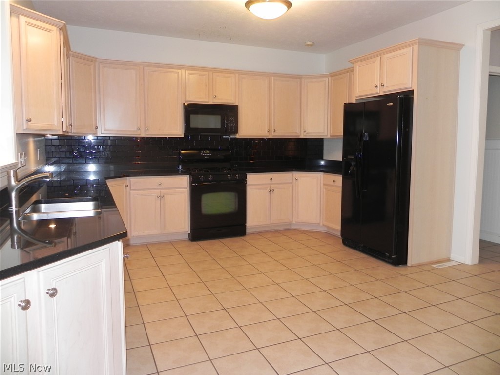Super-sized kitchen with granite counters and under cabinet lighting.