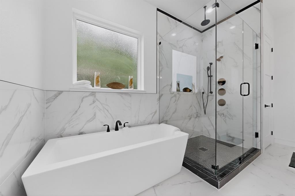 9080 County Road 669 Blue Ridge, TX 75424 - Photo 21 of 40 a bathroom with a tub a mirror and a shower