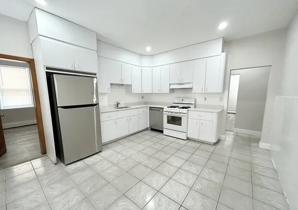 a kitchen with stainless steel appliances a refrigerator sink and microwave
