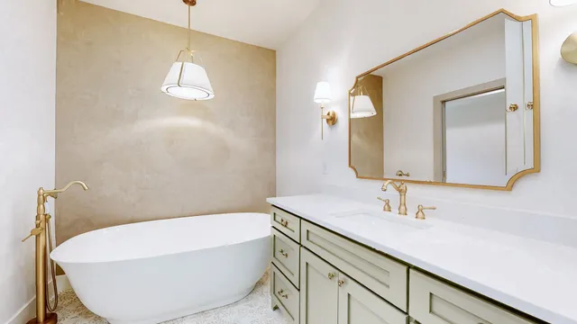 a bathroom with a bathtub a sink and a mirror