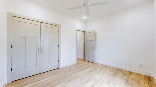 a view of an empty room with wooden floor