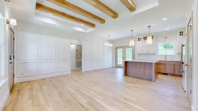 a view of a kitchen with a refrigerator and a sink