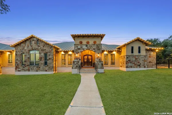 a front view of a house with a garden and yard