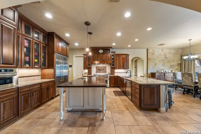a kitchen with granite countertop a stove and a sink