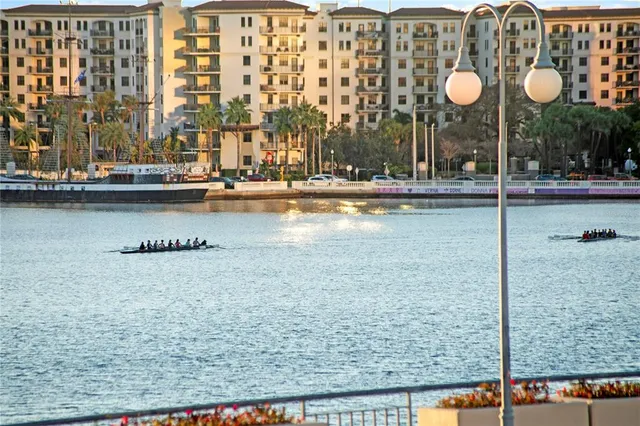 a living room with furniture kitchen view and a flat screen tv