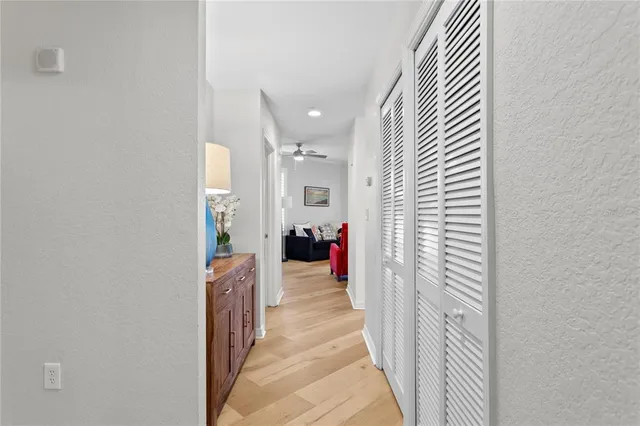 a view of a hallway with dining area and chandelier